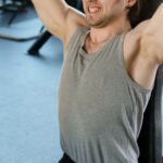 Weight Bench - Man Exercising at a Gym