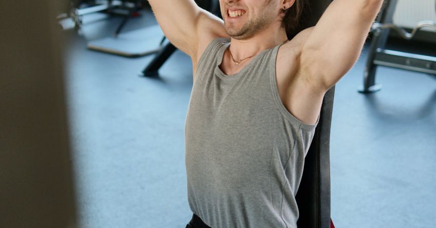 Weight Bench - Man Exercising at a Gym