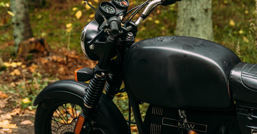 Motorized Treadmills - A Black Motorcycle Parked in a Forest