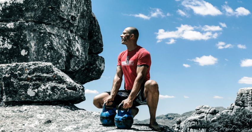 Kettlebells - Man Holding Kettlebells