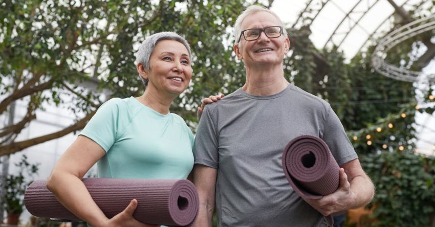 Yoga Mats - Couple Smiling While Holding Yoga Mats