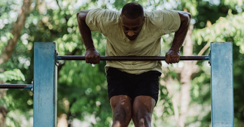 Pull-up Bar - A Man Pulling Himself over the Pull-up Bar